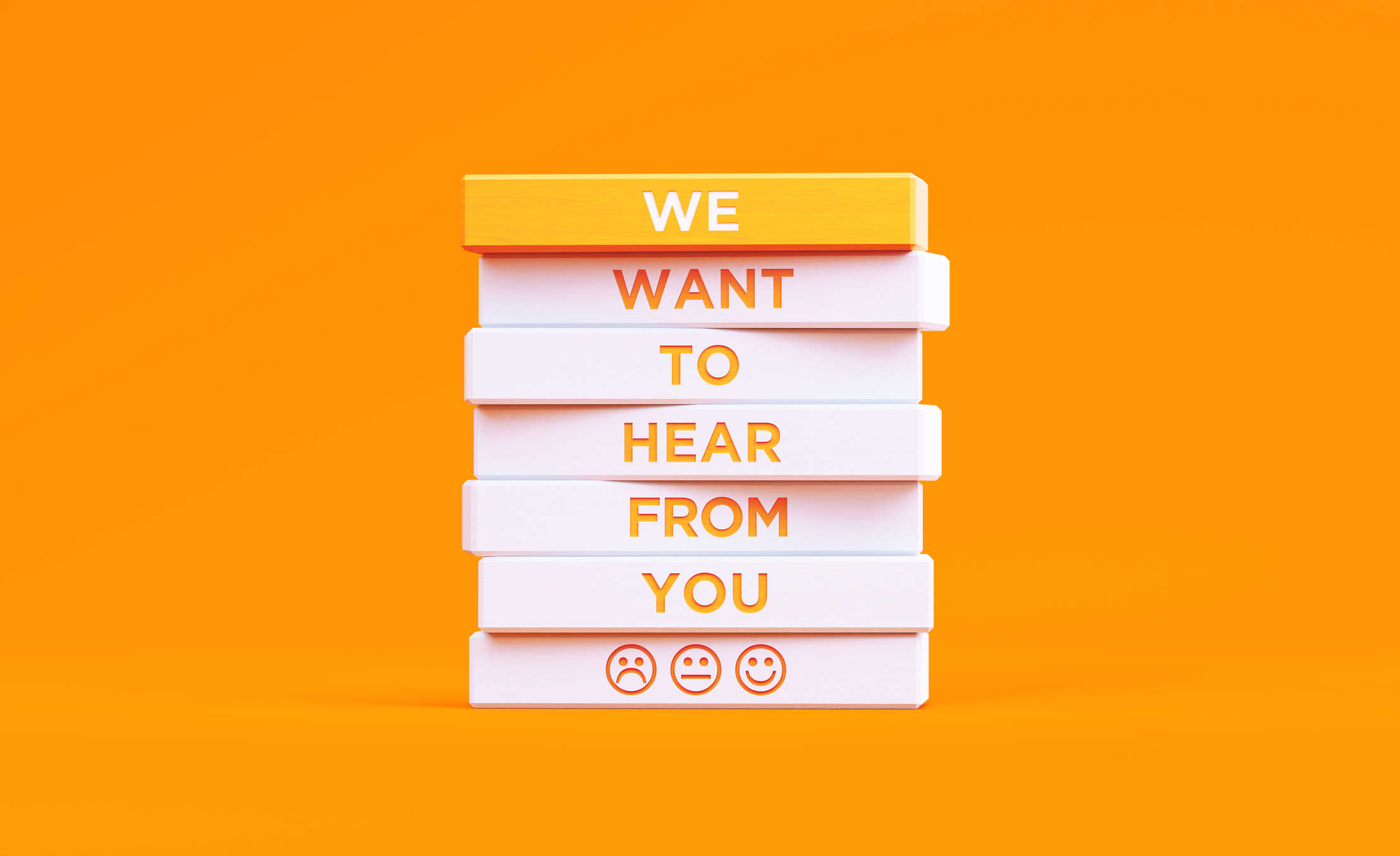 "We Want To Hear From You" written wood blocks on orange background. Feedback concept.